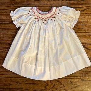 Smocked dress with red rosebud detail